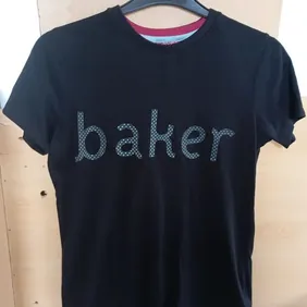 This is a Ted Baker T shirt, aged 13-14 years. The lettering is hologram/3D effect in that the "dots