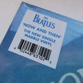 This exclusive vinyl record featuring The Beatles titled "Then And Now" is a must-have for any colle