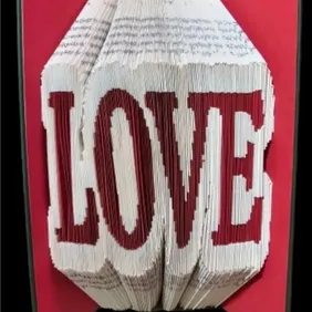 This random, plain covered book, is cut, folded and coloured with red card to form.the word LOVE.