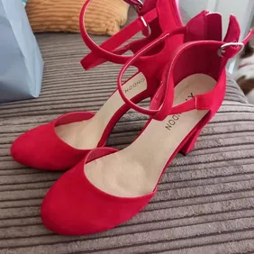 Brand new without tags red shoes size 4 nice thick heel zips at the back 