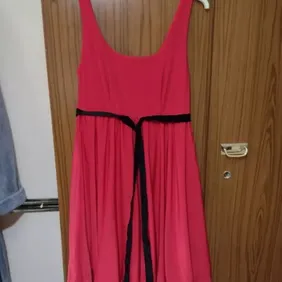 red bubble hem dress size 10 red thick material dress with black velvety tie round the chest and has