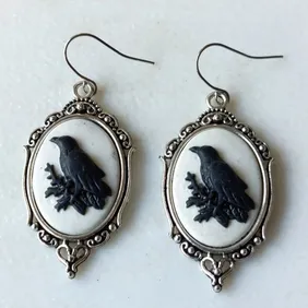 Steampunk silver plated oval pendant earrings with resin crow inset on silver plated hooks