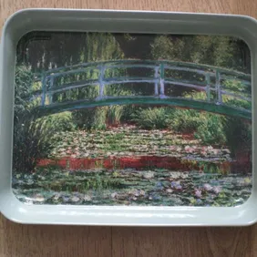 Small mint green metal tray with picture of a river scene on inside. Inside of tray measures approx 