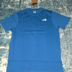 Never Worn Medium Blue North Face Tee with Tags!Brand new, authentic North Face t-shirt. Vibrant blu