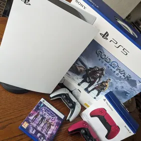 Barely used PS5 God of War Bundle. Includes 2 x controllers (white and red), God of War: Raganrok, G