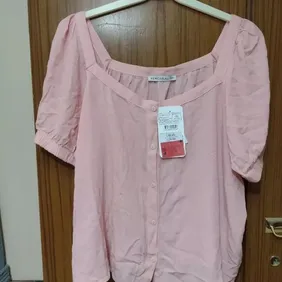 Light Pink Top Size 12-14. Says size xxl but will suit about 12-14   button front and short sleeves 