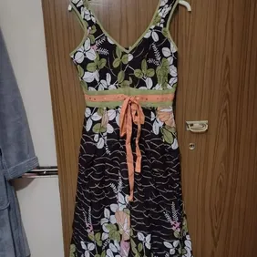 Boutique Dress Size 10 worn 2 times about calf length lined with tie in the middle and sequins is pa